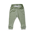 Green baby pants on a white background