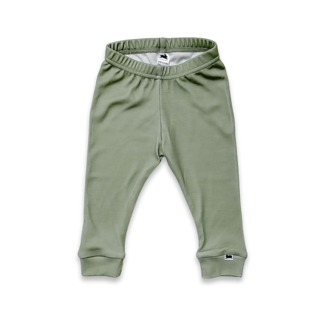 Green baby pants on a white background