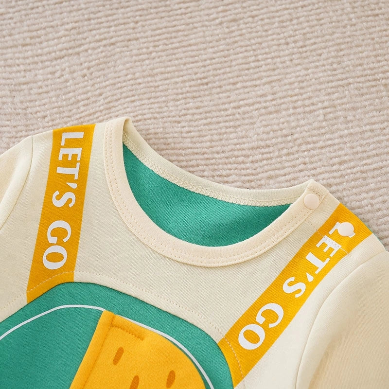 Children's outfit with 'Let's Go' text on a textured beige background